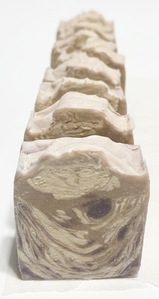 Row of soap bars with a wavy pattern on a dark countertop